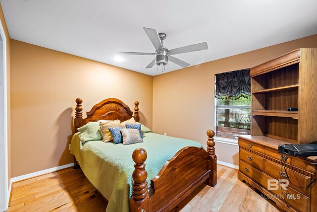 bedroom with ceiling fan and hardwood / wood-style flooring