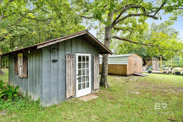 view of outdoor structure featuring a lawn