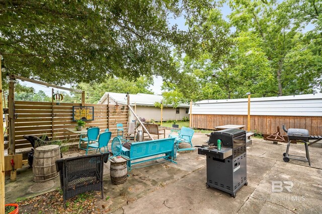 view of patio featuring an outdoor fire pit and area for grilling