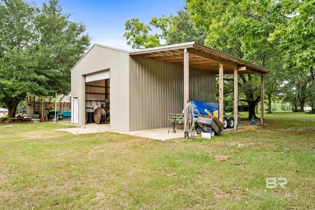 view of outdoor structure with a lawn and a garage