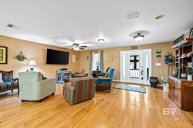 living room with ceiling fan and light wood-type flooring