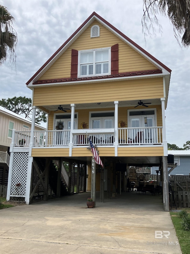 raised beach house featuring a porch and a carport