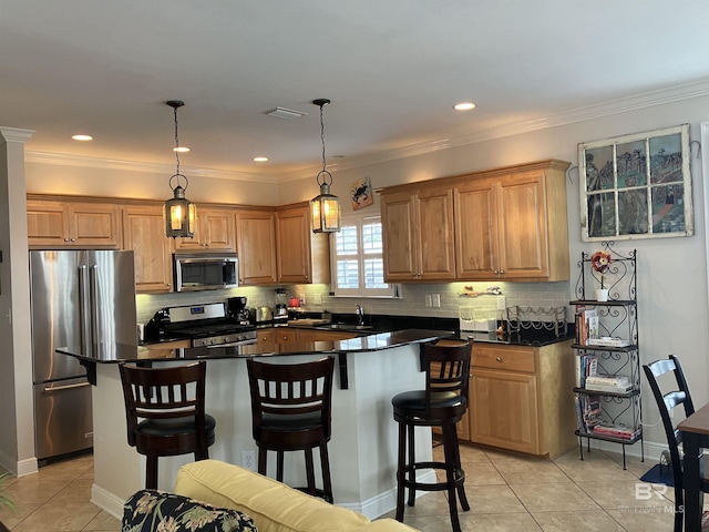 kitchen featuring sink, light tile patterned flooring, hanging light fixtures, and appliances with stainless steel finishes