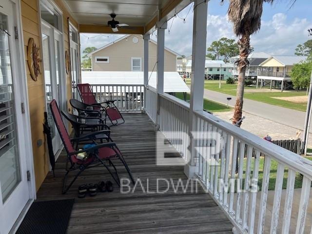 wooden terrace with covered porch and ceiling fan