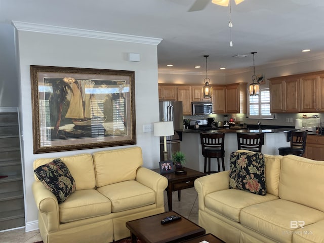 living room with light tile patterned floors and crown molding