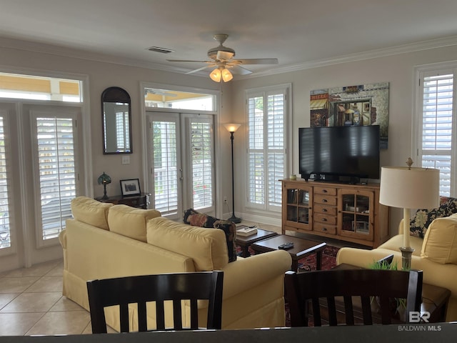 tiled living room with french doors, ceiling fan, and ornamental molding