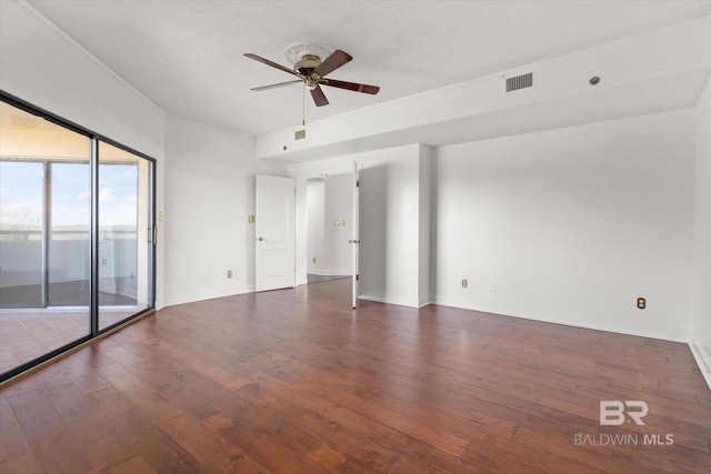 empty room with ceiling fan, a textured ceiling, visible vents, baseboards, and wood-type flooring