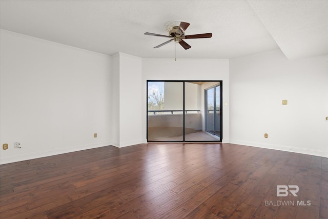 unfurnished room featuring dark wood-style flooring, ceiling fan, and baseboards