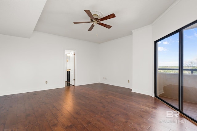 empty room featuring dark wood-style floors, baseboards, a ceiling fan, and ornamental molding