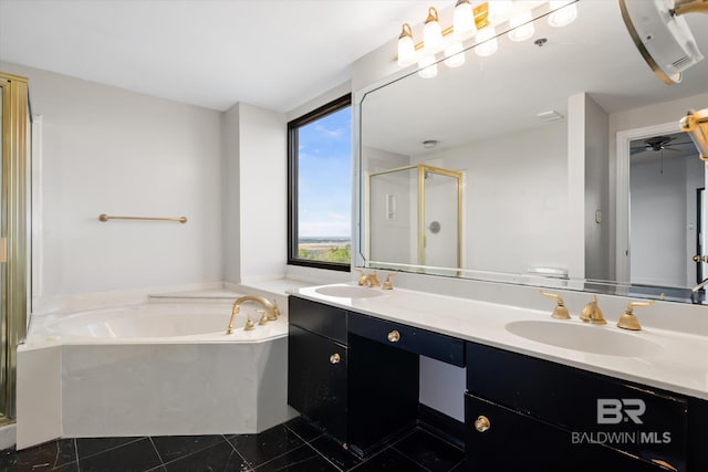 bathroom with double vanity, a stall shower, a garden tub, and a sink