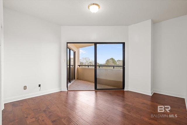 empty room featuring baseboards and wood finished floors