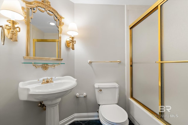 full bath featuring toilet, baseboards, and bath / shower combo with glass door