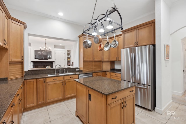 kitchen featuring ornamental molding, stainless steel appliances, sink, and light tile patterned floors