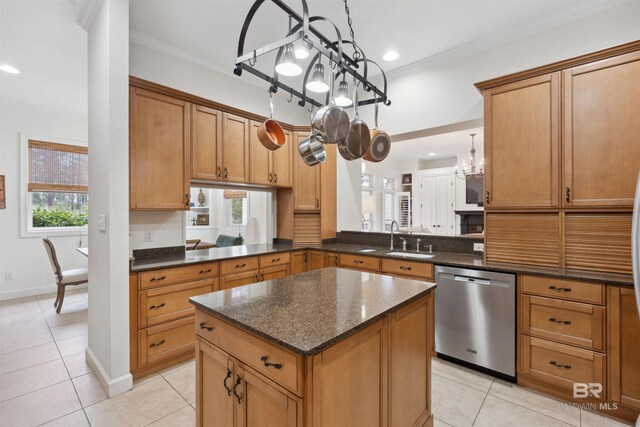 kitchen featuring sink, hanging light fixtures, stainless steel dishwasher, ornamental molding, and kitchen peninsula