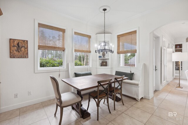 dining room with breakfast area, crown molding, and a healthy amount of sunlight