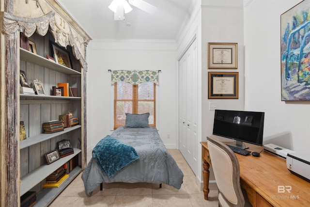 tiled bedroom with ornamental molding, a baseboard heating unit, ceiling fan, and a closet