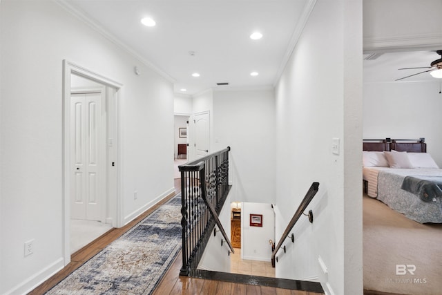 hall featuring crown molding and light hardwood / wood-style floors