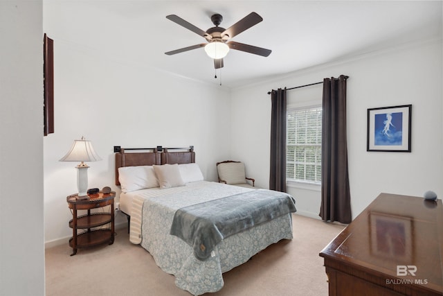 carpeted bedroom with crown molding and ceiling fan