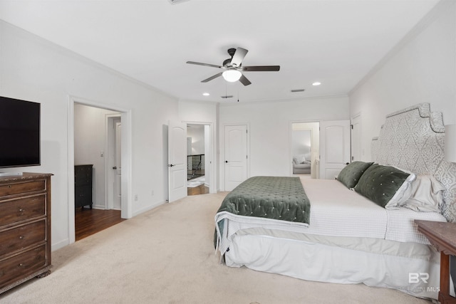 carpeted bedroom with ceiling fan and ensuite bathroom