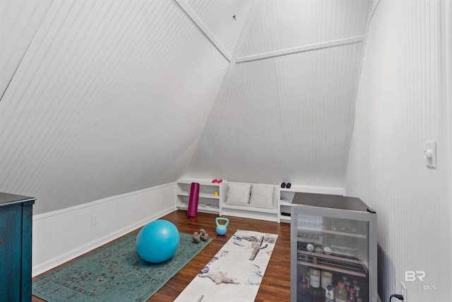 workout area with lofted ceiling, dark hardwood / wood-style floors, and wine cooler