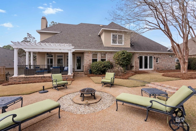 back of house featuring a pergola, a fire pit, and a patio area