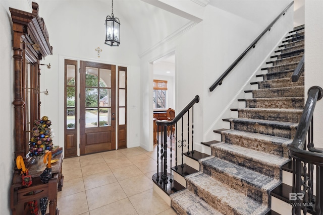 tiled foyer featuring crown molding