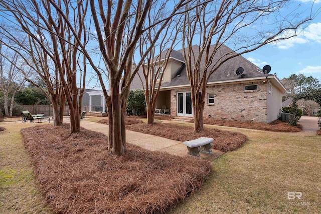 exterior space with central AC, a front yard, and a patio area