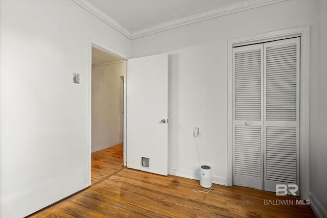 162 Westwood St, Mobile, AL 36606 - unfurnished bedroom with ornamental molding, wood finished floors, and a closet