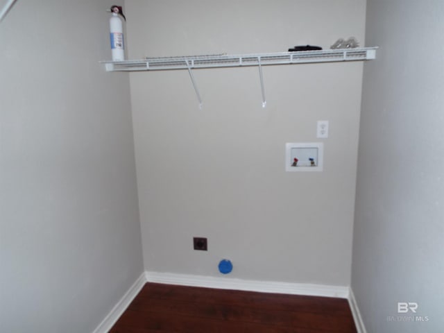 clothes washing area featuring hookup for a washing machine, hookup for an electric dryer, laundry area, baseboards, and dark wood finished floors