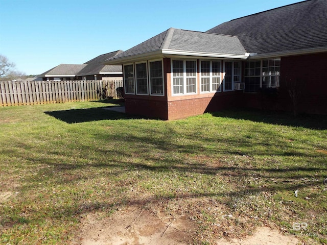 view of yard featuring a sunroom and fence