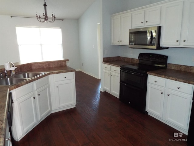 kitchen featuring stainless steel microwave, a sink, white cabinetry, and double oven range