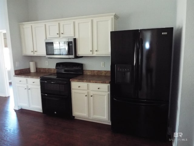 kitchen featuring dark countertops, white cabinetry, and black appliances