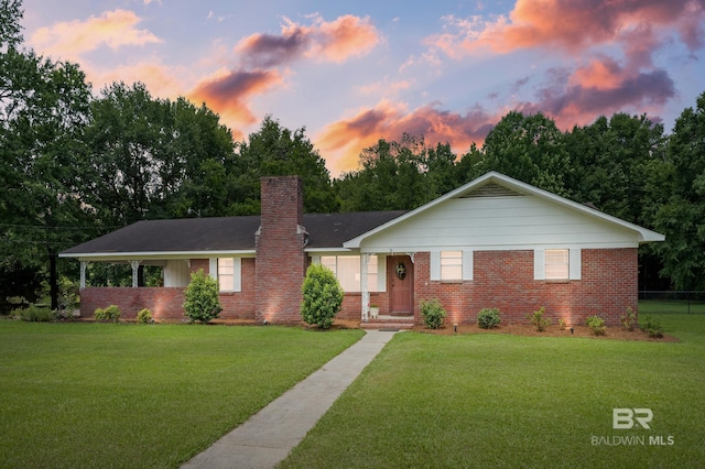 56 Old Bratt Rd, Atmore, AL 36502 - ranch-style house with brick siding, a lawn, and a chimney