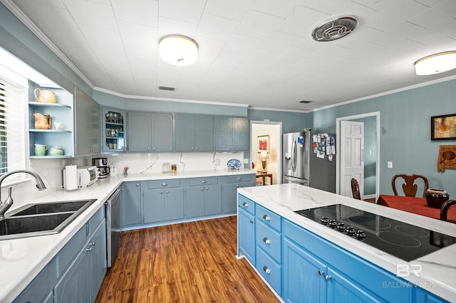 56 Old Bratt Rd, Atmore, AL 36502 - kitchen with appliances with stainless steel finishes, blue cabinets, a sink, ornamental molding, and dark wood-style flooring