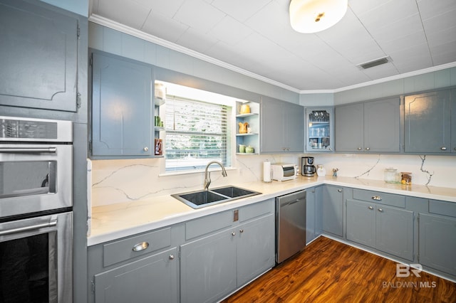 56 Old Bratt Rd, Atmore, AL 36502 - kitchen featuring appliances with stainless steel finishes, ornamental molding, gray cabinets, a sink, and dark wood-style flooring