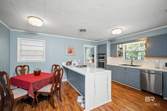 56 Old Bratt Rd, Atmore, AL 36502 - kitchen with stainless steel appliances, a sink, ornamental molding, gray cabinetry, and a peninsula