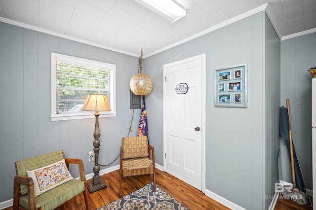 56 Old Bratt Rd, Atmore, AL 36502 - living area with ornamental molding, wood finished floors, a decorative wall, and baseboards