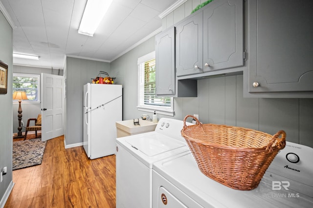56 Old Bratt Rd, Atmore, AL 36502 - washroom featuring washer and dryer, cabinet space, light wood-style floors, and crown molding