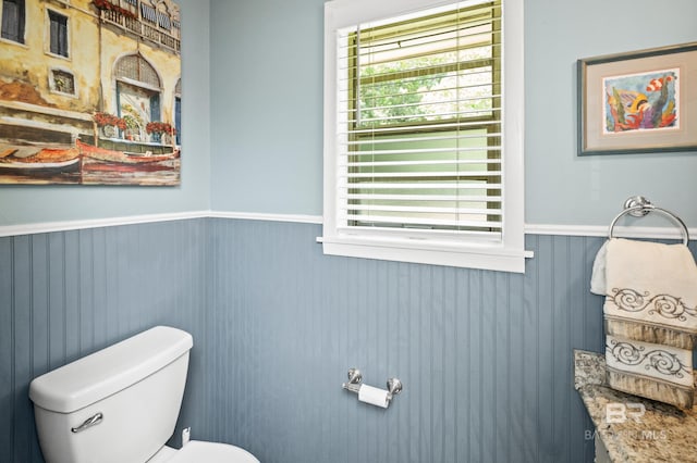 56 Old Bratt Rd, Atmore, AL 36502 - bathroom featuring wainscoting, toilet, and healthy amount of natural light
