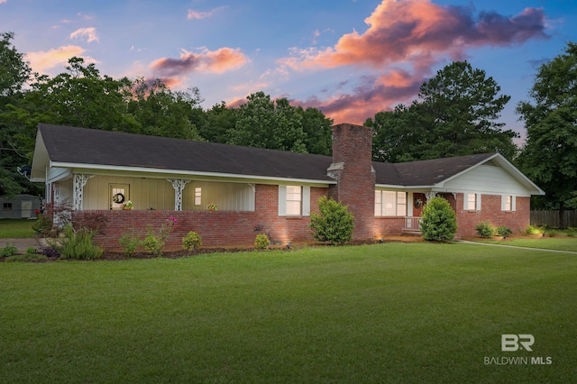 56 Old Bratt Rd, Atmore, AL 36502 - single story home with brick siding, a lawn, and a chimney