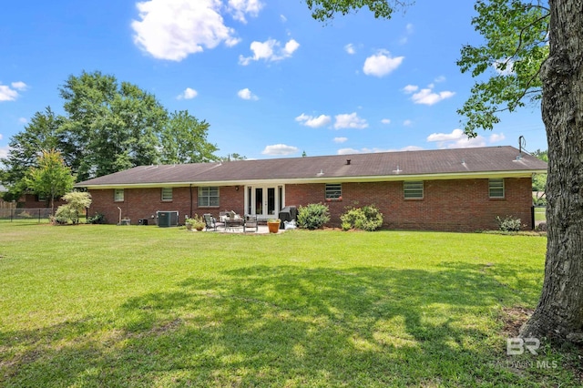 56 Old Bratt Rd, Atmore, AL 36502 - back of property featuring french doors, brick siding, a patio area, and cooling unit