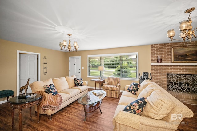 56 Old Bratt Rd, Atmore, AL 36502 - living room featuring a chandelier, wood finished floors, baseboards, and a fireplace