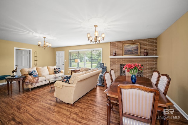 56 Old Bratt Rd, Atmore, AL 36502 - living room featuring a chandelier, wood finished floors, baseboards, and a fireplace