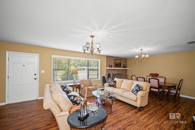 56 Old Bratt Rd, Atmore, AL 36502 - living area with a chandelier, wood finished floors, baseboards, and a fireplace