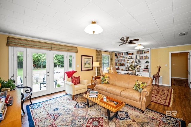 56 Old Bratt Rd, Atmore, AL 36502 - living area with ornamental molding, wood finished floors, french doors, ceiling fan, and baseboards