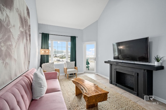 living room with light tile floors and vaulted ceiling