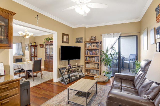 living area with crown molding, ceiling fan with notable chandelier, dark wood-style floors, and a wealth of natural light