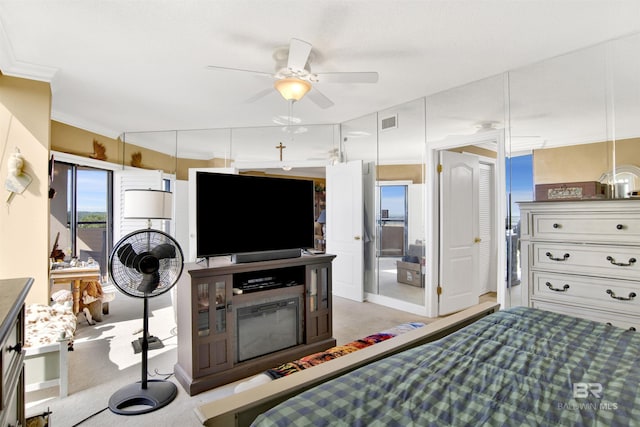 bedroom featuring visible vents, crown molding, and light carpet