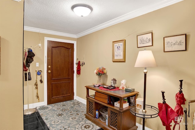 tiled entryway featuring baseboards, ornamental molding, and a textured ceiling