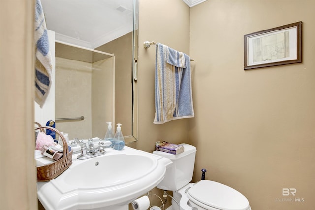 bathroom with crown molding, a sink, and toilet